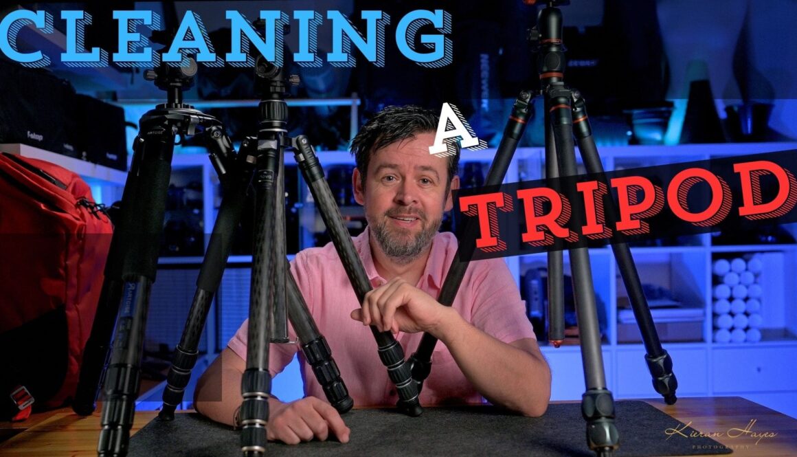 A man and three tripods on a desk showing how to clean a tripod easily.